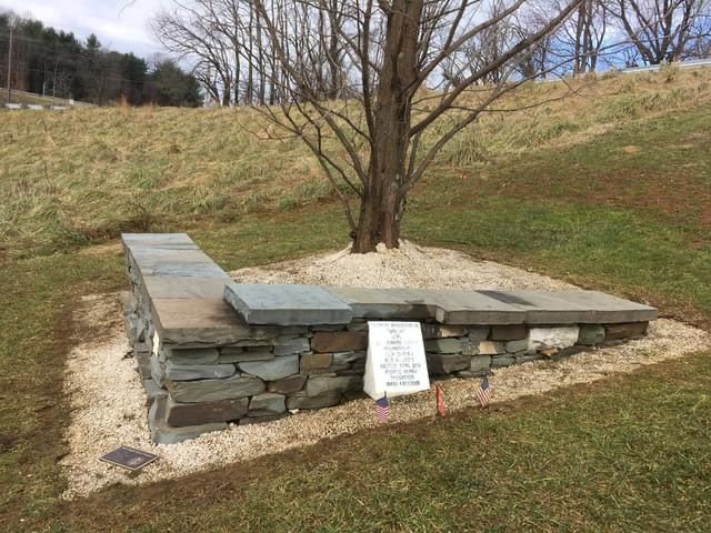 Balducci Bluestone tree surrounded by stone memorial wall